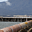 Rusty pipes extend out to the end of a pier at the old Po...